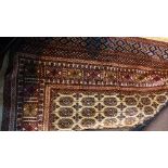 A Bokhara style carpet, with elephant pad motifs on a beige ground, contained by geometric