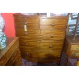 A Victorian mahogany bow front chest, with two short over three long drawers, raised on splayed