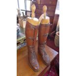 A pair of early 20th century brown leather riding boots with trees by Peal & Co.