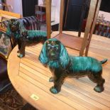 Two green glazed King Charles spaniels, H.27 W.36cm (largest) (2)