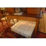 A mid 20th century beech wood writing table, with stained top, two drawers raised on tapered legs,