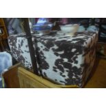 A contemporary footstool upholstered in faux cow hide, H.39cm L.99cm W.51cm