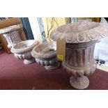 A pair of pink variegated marble garden urns, on socle bases, H.52cm (one with chip to rim)