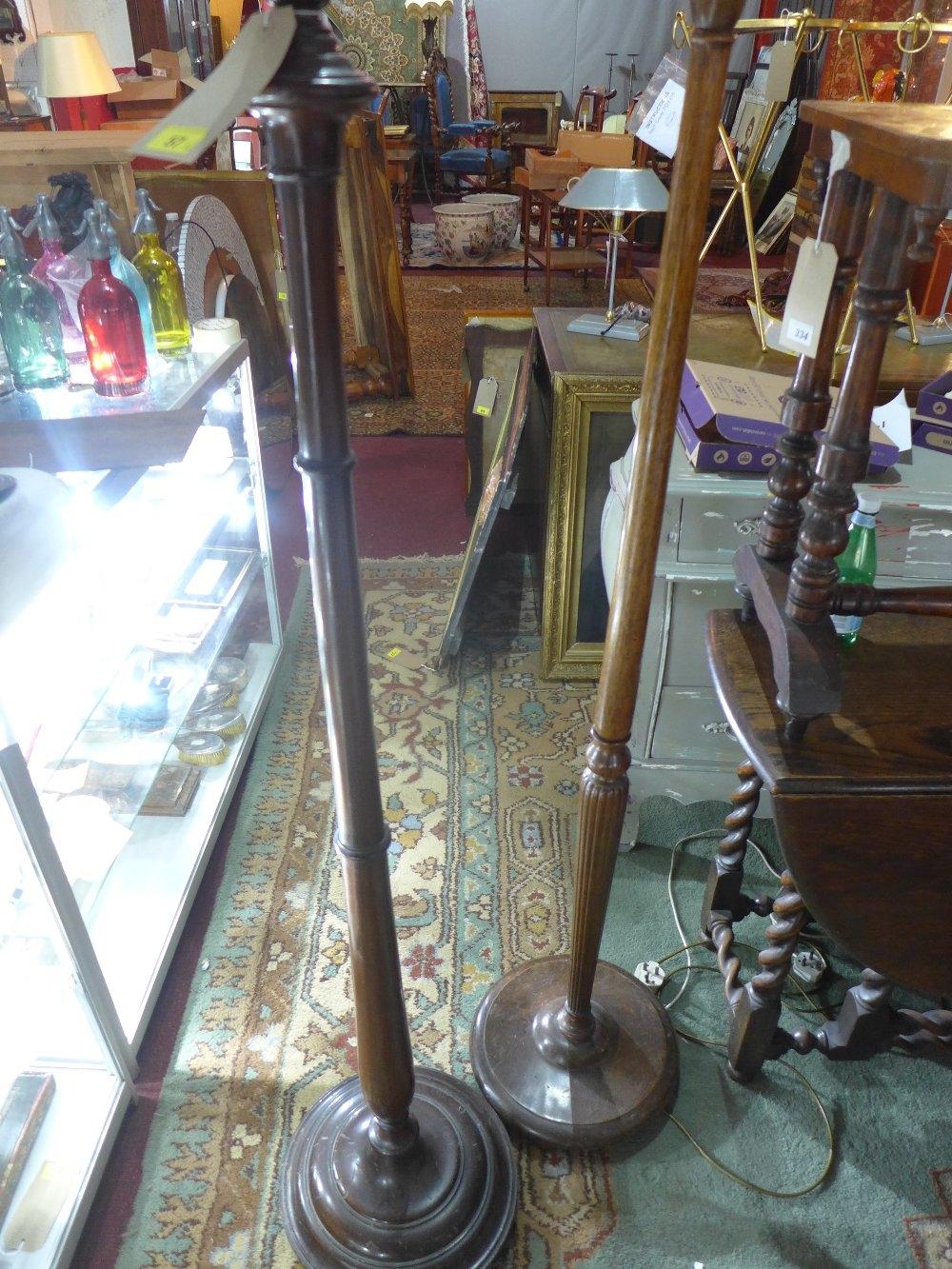 A mahogany standard lamp base, H.160cm, together with an oak standard lamp base, H.158cm