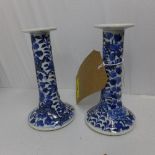 A pair of Chinese blue and white porcelain candlesticks, decorated with dragons amongst flowers, H.