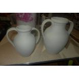 Two twin handled ceramic urns, H.30cm and H.24cm (2)