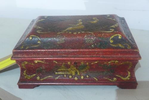 A red lacquered box, of casket form, decorated in the Chinoiserie taste with figures and scrolling