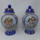 A pair of baluster vases and covers decorated with cherubs and flowers, bears marks to bases, H.33cm