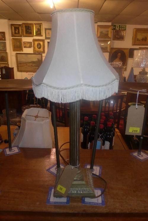 An Edwardian brass Corinthian column form table lamp with tasseled shade