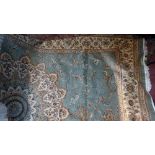 A Kashan style carpet, with central floral medallion on a green ground, contained by floral borders,