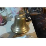 A large gilt grass and iron ships bell and hook