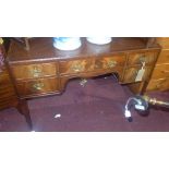 A Georgian style mahogany desk, with leather top, five drawers, raised on tapered legs, H.76 W.106