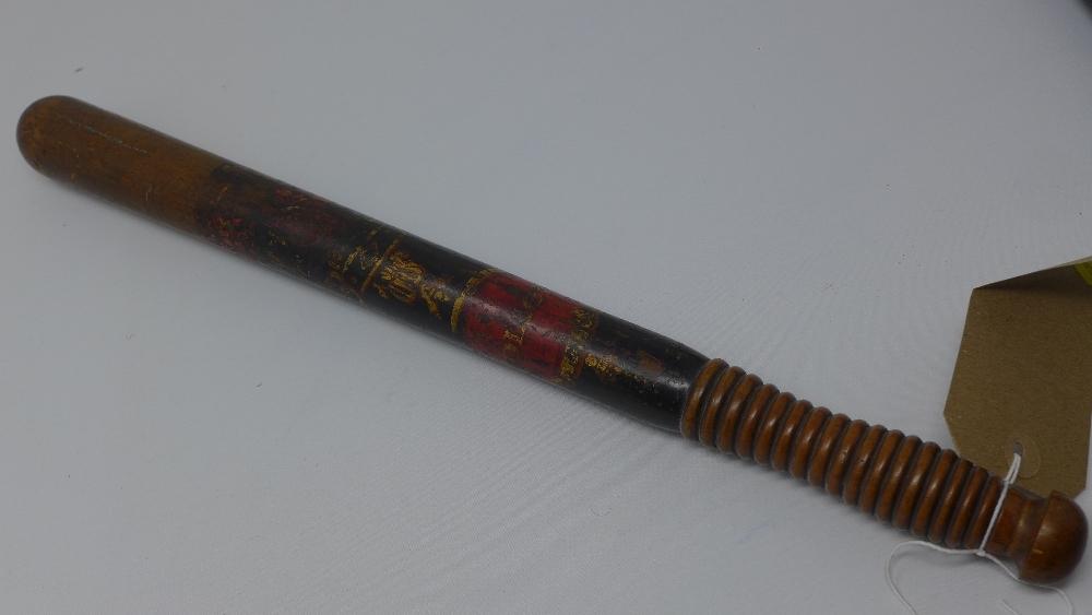 A Victorian police truncheon, ebonised and with indistinct crest, H.46cm