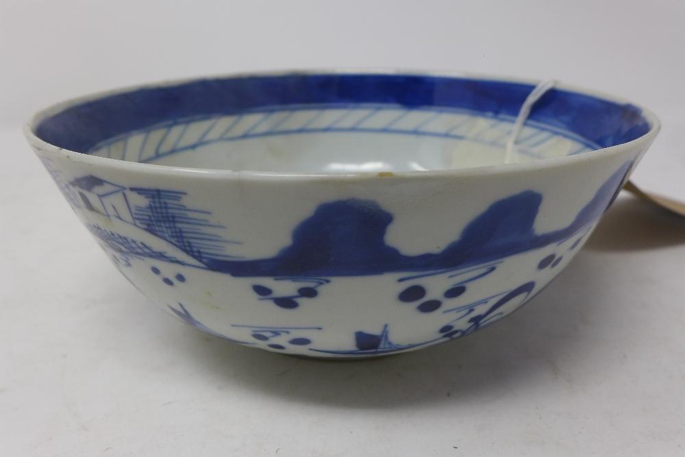 A late 19th century Chinese blue and white bowl, decorated with boats, bears four character marks,