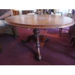 A Victorian mahogany oval loo table, with baluster support, raised on three carved scroll legs and
