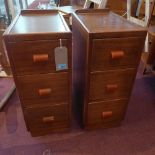 A pair of Art Deco walnut pedestal chest, with three drawers, having bakelite handles, raised on
