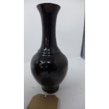 A 19th century Chinese mirror black vase, having elongated neck and flared rim, H.20cm