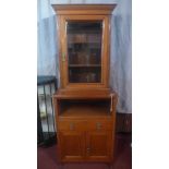 An early 20th century walnut bookcase, with bevelled glazed door, above recess, a single drawer