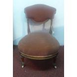 A late 19th Century Victorian walnut nursing chair, with salmon plush upholstery raised on fluted