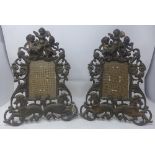 A pair of Edwardian cast iron photo frames, decorated with cherubs, scrolling foliage and sea