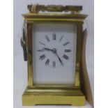 A polished brass carriage clock, white enamel dial with Roman numerals, chiming gong, H.17cm