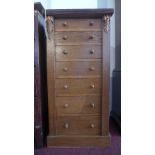 An oak Wellington chest of seven drawers, with floral carving, H.103 W.50 D.35cm