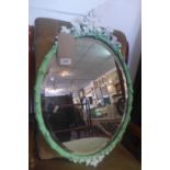 A Victorian wall mirror, with an oval bevelled plate within green painted gesso frame, H.64cm W.43cm