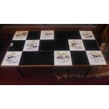 A vintage French low table, with a tiled top over black dansette legs