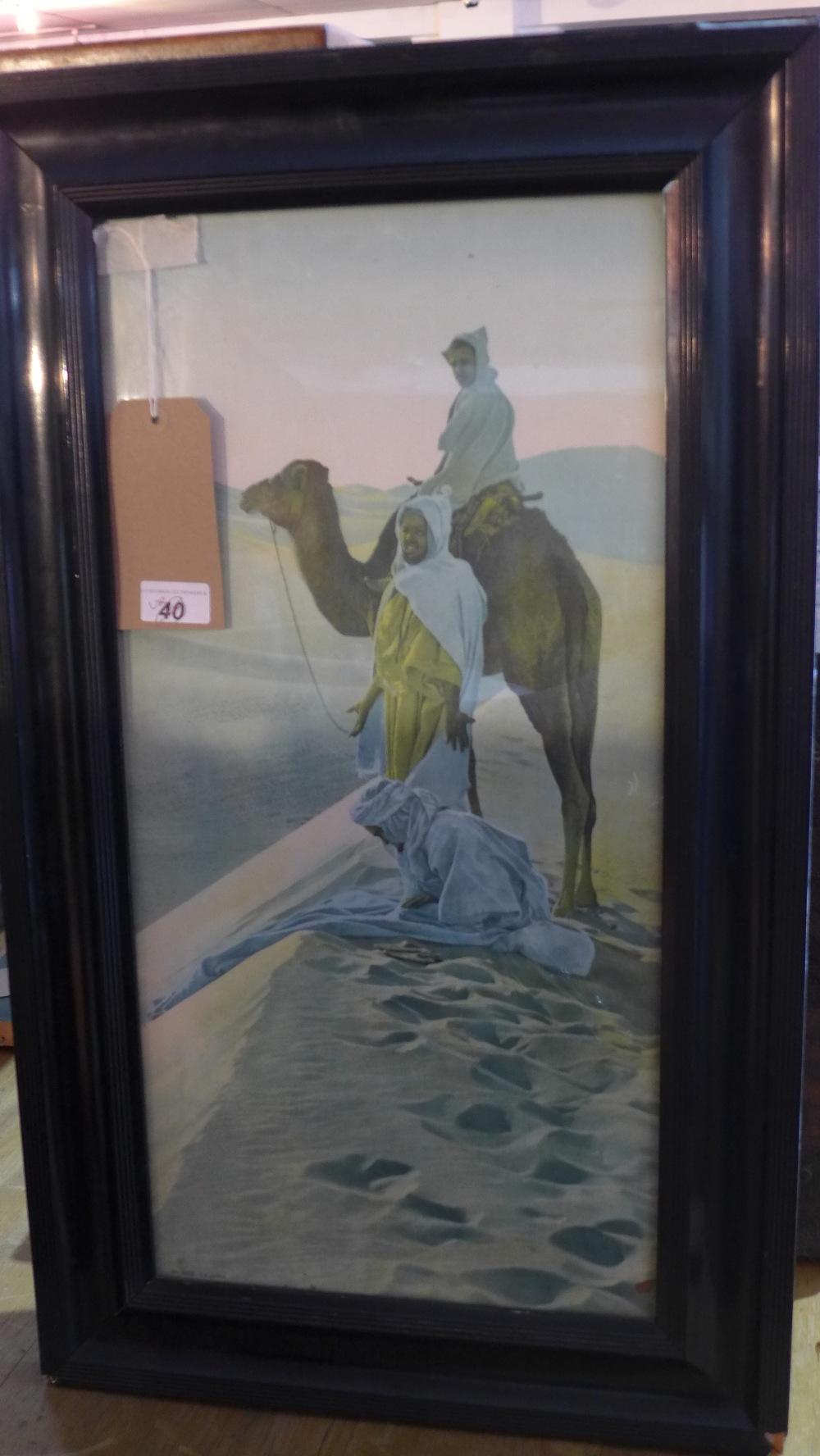 A print of three figures and a camel in the desert, published by La Piere, framed and glazed, 59 x