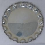 An Argentinian silver charger with scalloped border, stamped 900, 24oz