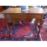 A 19th century mahogany side table, with one long drawer over two short drawers, raised on tapered