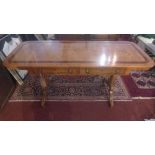 A William IV pollard oak library table, with mahogany crossband, having two drawers and two faux