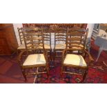 A set of six oak ladder back dining chairs to include two carvers