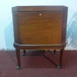 A Regency mahogany cellarette on stand, with ivory escutcheon, lead lining, raised on tapered legs