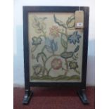 An Art Nouveau fire screen, with glazed stump work embroidered panel