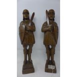 A pair of 19th century carved oak figures of soldiers, on stepped pedestal bases, H.48cm