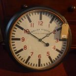 A large circular wall clock, white dial with Arabic numerals, dial marked 'English Electric Clock