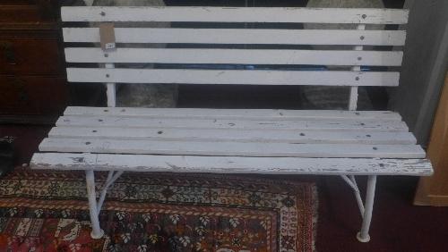 A garden bench with white painted slats on a tubular metal frame, H.75cm W.140cm