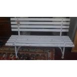A garden bench with white painted slats on a tubular metal frame, H.75cm W.140cm