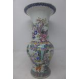 A Chinese famille rose vase decorated with figures in courtyard scenes, bearing character marks to