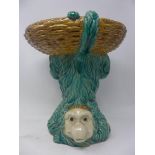A turquoise glazed Majolica dish on a naturalistic monkey base, H.32cm