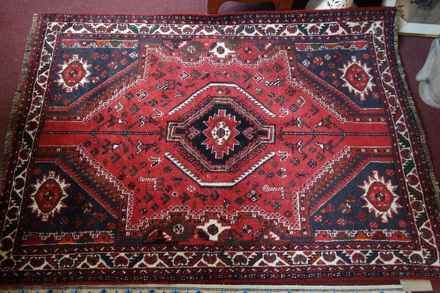 A fine South West Persian Qashgai rug, 182cm X 134cm. Central diamond medallion with repeating petal