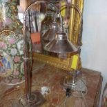 A pair of Art Deco style nickel plated desk lamps, with adjustable arms