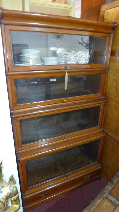 An early 20th century mahogany Globe Wernicke waterfall stacking bookcase, in four sections with one