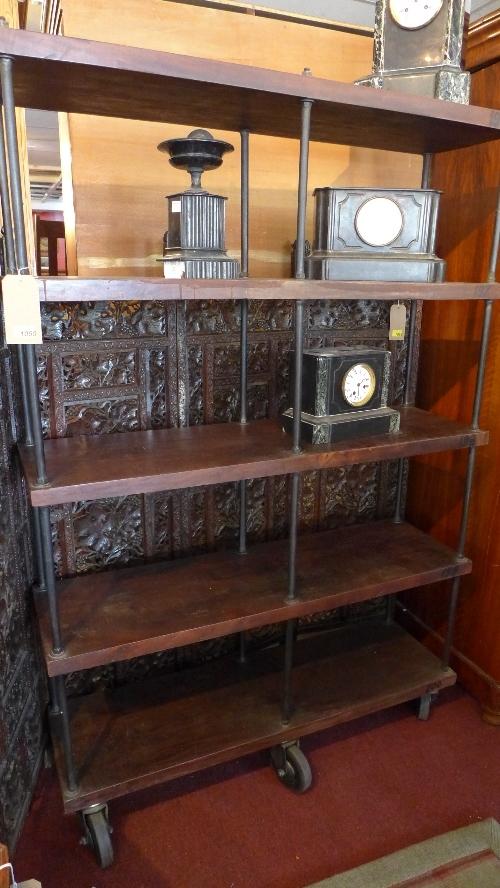 A large industrial display unit/bookcase, with five solid teak planks having iron rod supports,