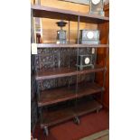 A large industrial display unit/bookcase, with five solid teak planks having iron rod supports,