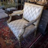 A pair of early 20th century Louis XV style cream and gilt armchairs, with silk checkered zig zag