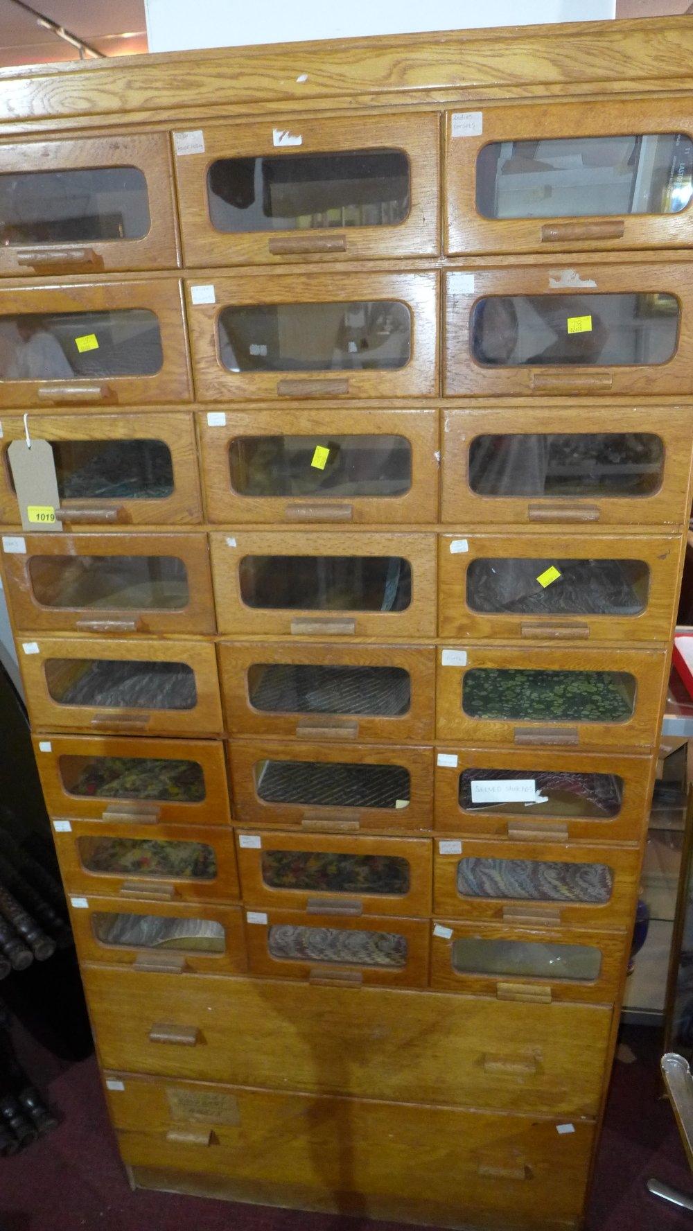 An early to mid 20th century light oak Haberdashery cabinet with 24 glass fronted drawers, above two - Image 2 of 2