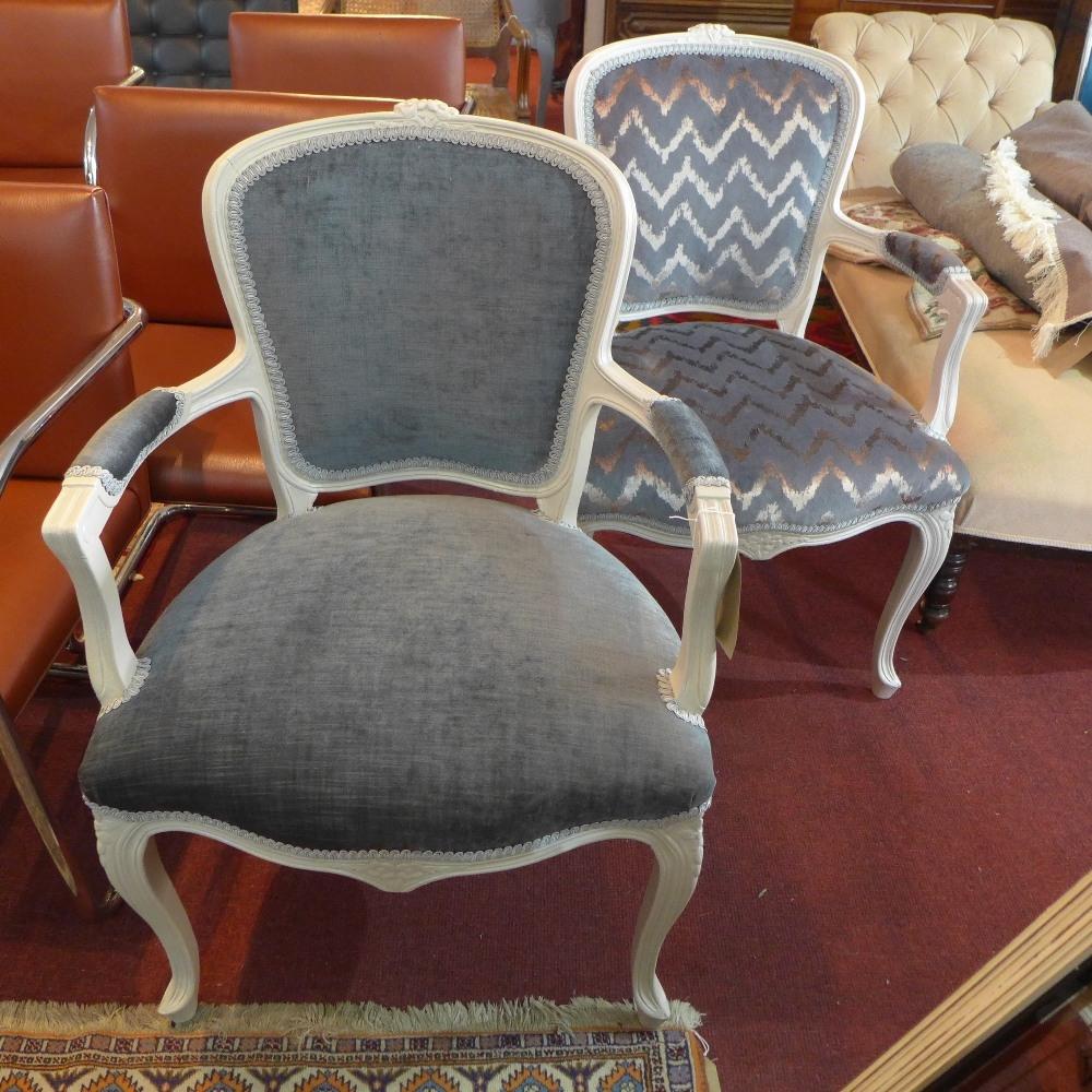 A pair of Louis XV style grey painted fauteuils, recently upholstered, raised on cabriole legs