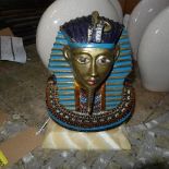 An Art Deco enamelled brass bust of Tutankhamen, raised on alabaster base, H.27cm